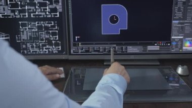 Designer using computer and stylus pen