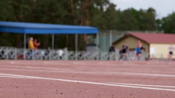 Male Athletes Run Sprint Race Stadium Slow Motion Focus Foreground — Vídeos de Stock