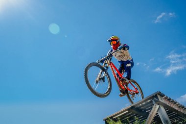 Green Glade; Russia - July 16; 2022: athlete gap jump in protective clothing Fox racing and goggles 100% during Ural Downhill Cup