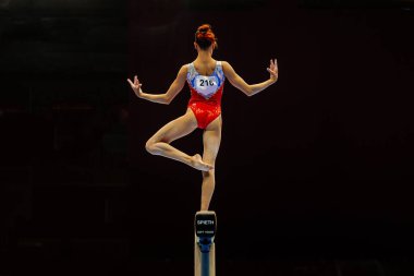 Kadın jimnastikçi, siyah arka planda egzersiz dengesi, Spieth denge ışını modeli yumuşak dokunuş, yaz sporları oyunları.