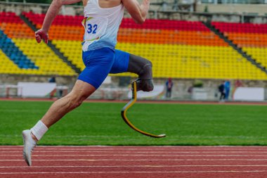 Yakın plan bacaklı atlet protezde koşucu stadyum pistinde koşucu, engelli atlet para atletizm yarışması, yaz sporları oyunları