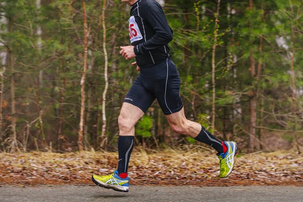 stock image male runner run road park spring marathon in Asics running shoes and Mizuno compression socks