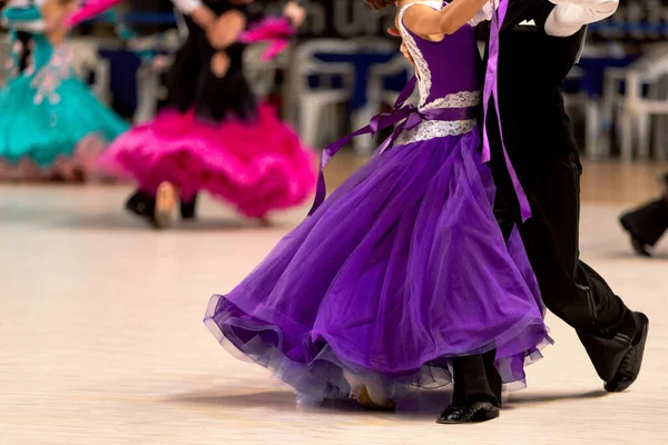 在舞蹈比赛中跳华尔兹舞的年轻夫妇们 女孩子穿五颜六色的衣服 男孩子穿黑色的燕尾服 — 图库照片