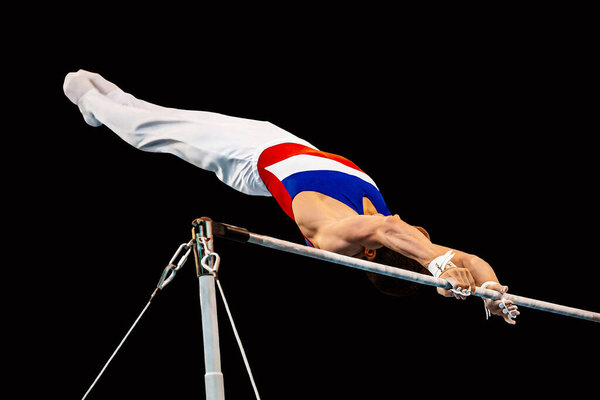 athlete gymnast exercise horizontal bar in championship gymnastics artistic, black background