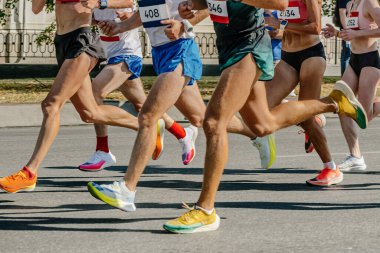bacak koşucuları kadın ve erkekler şehir maratonunda koşuyor, grup sporcuları birlikte koşuyor