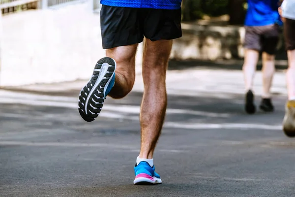 close-up sole of running shoe male runner, summer marathon race