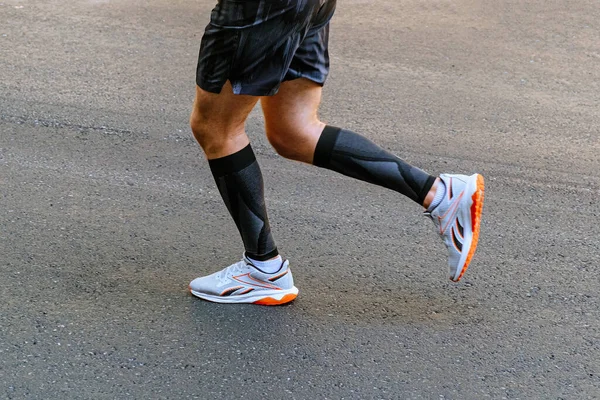 Legs Male Runner Black Compression Sleeves Running Asphalt Road Marathon — Stock Photo, Image