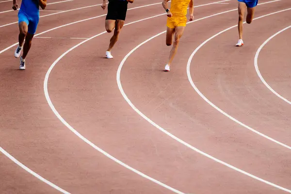 stock image beginning 800-meter race, men legs, running red track stadium