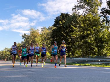 Monza, Italy - September 15, 2024: group athletes running race during Monza21 half marathon clipart