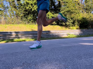 Monza, Italy - September 15, 2024: legs runner athlete in Nike running shoes during Monza21 half marathon clipart