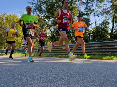 Monza, Italy - September 15, 2024: group athletes with pacemaker running race during Monza21 half marathon clipart