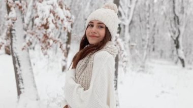 Portrait Young cute cute attractive woman girl walking in winter park, having fun, twirling, smiling, winter fun, christmas holidays, fun winter, snowfall. High quality 4k footage