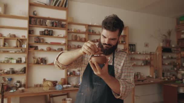 Happy Satisfied Bearded Stylish Potter Examines Demonstrates His Finished Product — Stockvideo