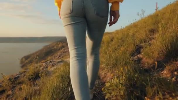Woman Yellow Sweater Walks Edge Cliff Wide River Sunset Raises — Stock Video