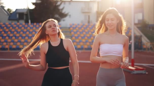 Two Girl Friends Talking Hugging Training Stadium Concept Sport Active — Stock Video