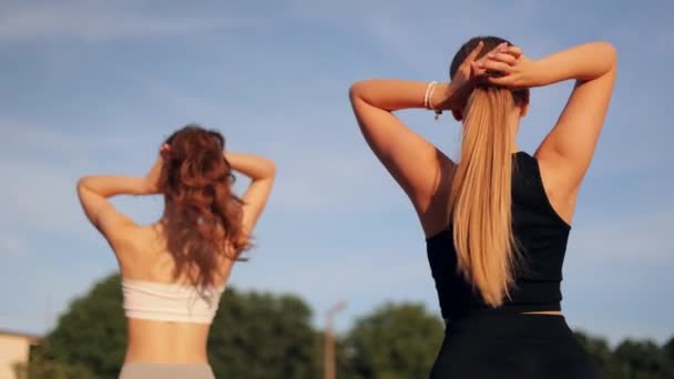 Two Young Female Friends Tie Long Hair Bun Sports Training — Stock Video
