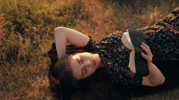 Молодая Женщина Читает Библию Лежа Траве Холме Невероятным Видом Реку — стоковое видео