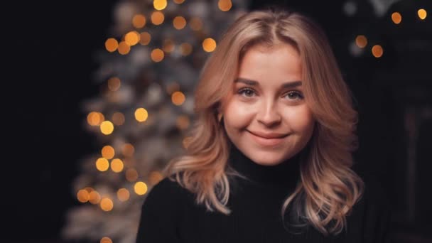 Young Sympathetic Blonde Girl Unwraps Christmas Presents While Sitting Christmas — Stock Video