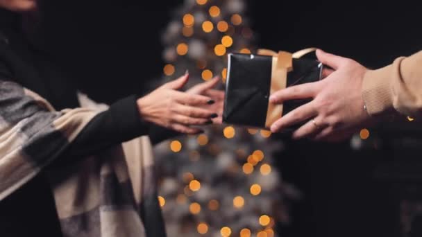 Detailní Záběr Mužských Rukou Dává Dárek Černém Vánočním Balicím Papíru — Stock video