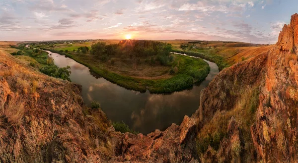 The river bent around granite massifs near the Ukrainian village of Starolaspa at sunset. Bend of a river.