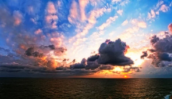 Calm sea with gorgeous sky, sunset. Magnificent  ocean and sky. Horizon over the water.