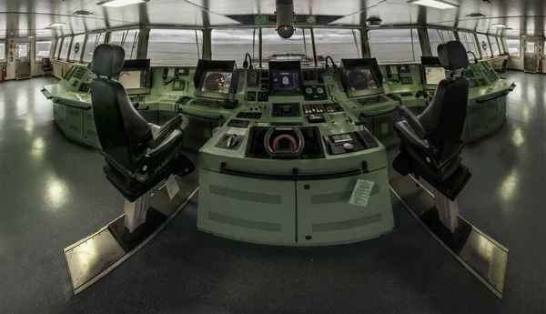 View of the control console on the navigation bridge of cintainer vessel.