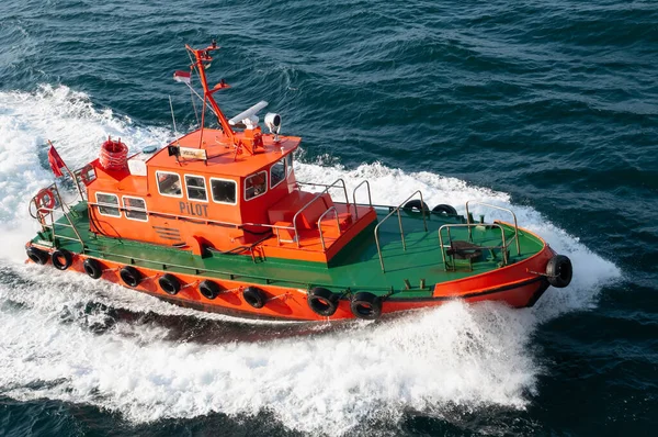 The pilot boat approaches the ship to bring the pilot on board. The pilot advises the captain on the departure or arrival of the ship in the harbor.