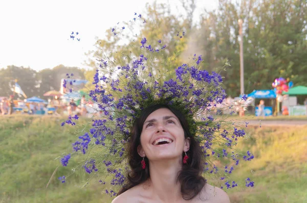 A smiling ukrainian woman in flower wreath on the Ivan Kupala is a traditional annual Slavic holiday. Midsummer day.