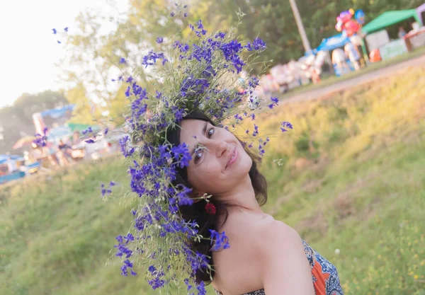 Ukrainian woman in flower wreath. The symbol of the summer solstice is a flower crown. Slavic ceremony on Midsummer Day, Wiccan sabbath Lita. Pagan holiday Ivan Kupala