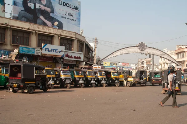 Black and yellow auto rickshaw or tuk-tuk parked on the street in India