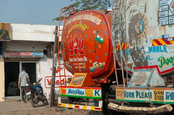 Gandhidham, Gujarat, India - 12 02 2022: Typical, colourful, decorated tank truck in India parked on the street. From behind.