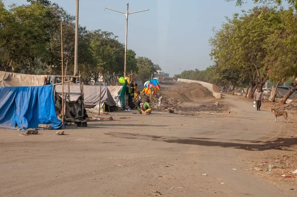 A lot of poor people living in slum out of city.