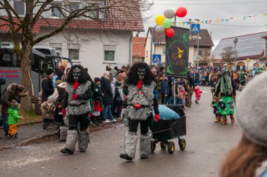 Hohenstadt - February 17, 2023: Participant of a parade with werewolf mask at the traditional carnival parade in Hohenstadt, Germany.
