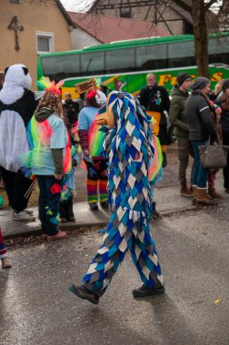 Hohenstadt - February 17, 2023: Participant of a parade with colourful costumes at the traditional carnival parade in Hohenstadt, Germany.