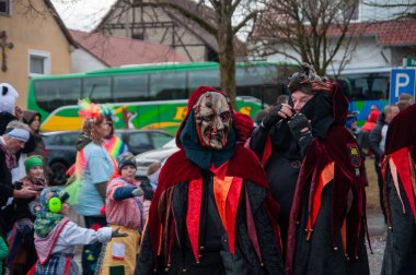 Hohenstadt - February 17, 2023: Participant of a parade with terrible mask at the traditional carnival parade in Hohenstadt, Germany.