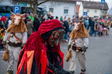 Hohenstadt - February 17, 2023: Participant of a parade with terrible mask at the traditional carnival parade in Hohenstadt, Germany.