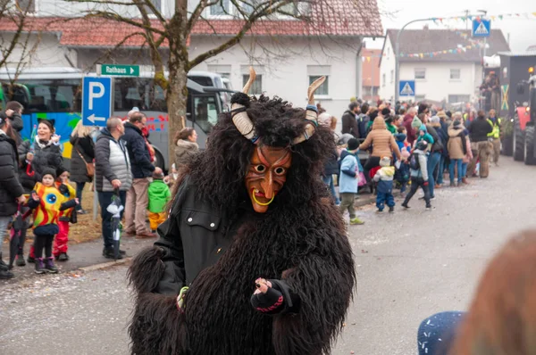 Hohenstadt - February 17, 2023: Participants of a parade with traditional costumes at the carnival parade in Hohenstadt, Germany.