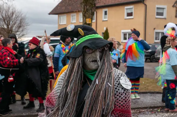 Hohenstadt - February 17, 2023: Participant of a parade with witch masks and costumes at the traditional carnival parade in Hohenstadt, Germany.