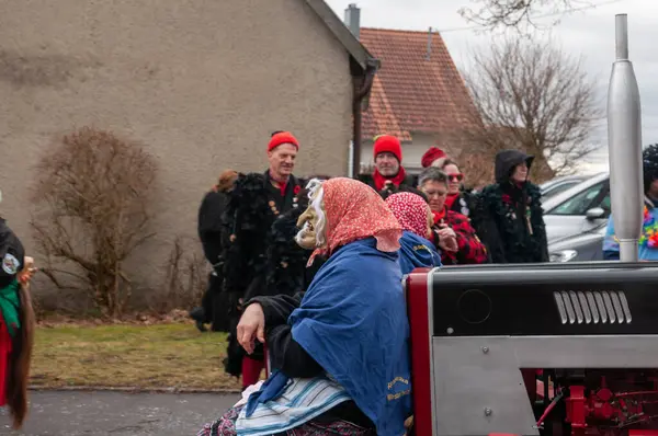 Hohenstadt - February 17, 2023: Participants of a parade with traditional costumes at the carnival parade in Hohenstadt, Germany.