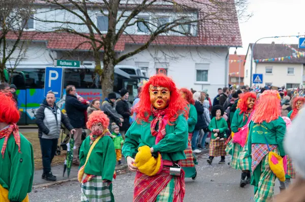 Hohenstadt - February 17, 2023: Participants of a parade with traditional costumes at the carnival parade in Hohenstadt, Germany.