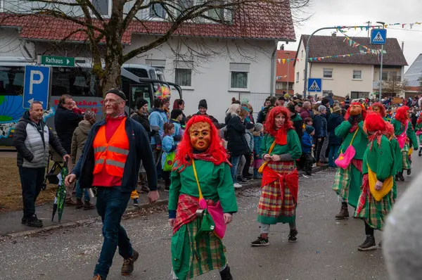Hohenstadt - February 17, 2023: Participants of a parade with traditional costumes at the carnival parade in Hohenstadt, Germany.