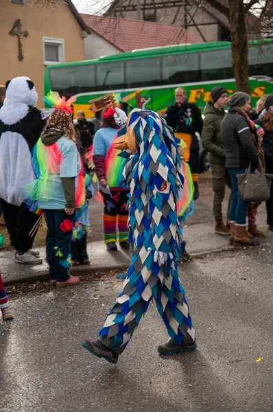 Hohenstadt - February 17, 2023: Participant of a parade with colourful costumes at the traditional carnival parade in Hohenstadt, Germany.