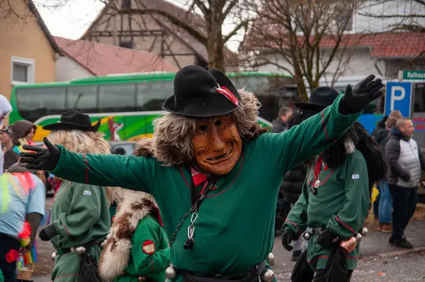 Hohenstadt - February 17, 2023: Participants of a parade with traditional costumes and masks at the carnival parade in Hohenstadt, Germany.