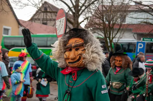 Hohenstadt - February 17, 2023: Participants of a parade with traditional costumes and masks at the carnival parade in Hohenstadt, Germany.