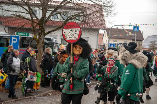Hohenstadt - February 17, 2023: Participants of a parade with traditional costumes and masks at the carnival parade in Hohenstadt, Germany.