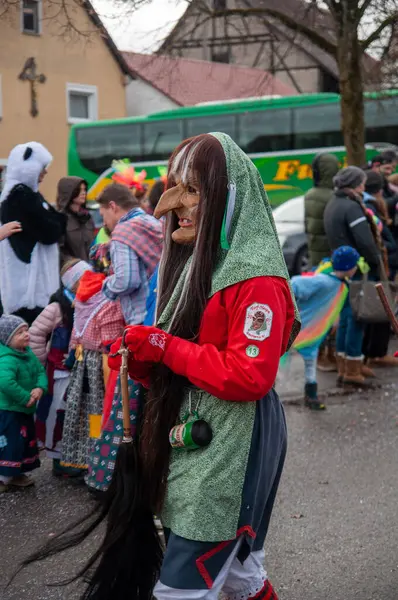 Hohenstadt - February 17, 2023: Participant of a parade with witch masks and costumes at the traditional carnival parade in Hohenstadt, Germany.