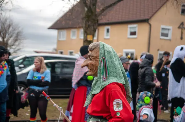 Hohenstadt - February 17, 2023: Participant of a parade with witch masks and costumes at the traditional carnival parade in Hohenstadt, Germany.