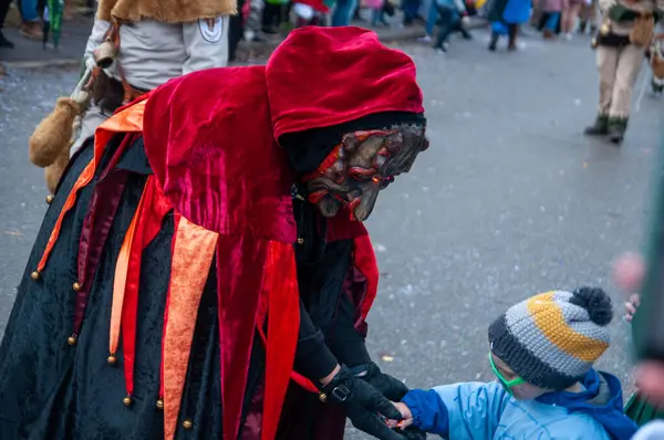 Hohenstadt - February 17, 2023: Participant of a parade with terrible mask at the traditional carnival parade in Hohenstadt, Germany.