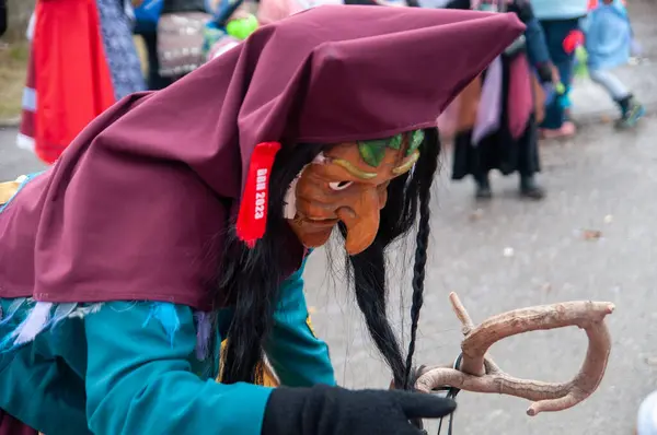 Hohenstadt - February 17, 2023: Participant of a parade in witch mask and costume at the traditional carnival parade in Hohenstadt, Germany.