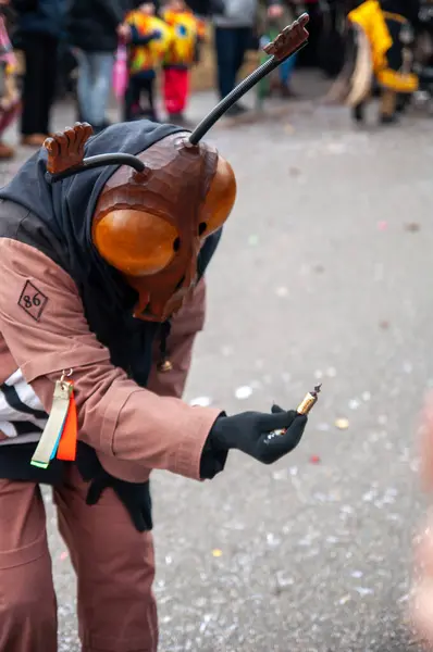 Hohenstadt - February 17, 2023: Participant of a parade in beetle masks and costumes at the traditional carnival parade in Hohenstadt, Germany. Distribute sweets to children